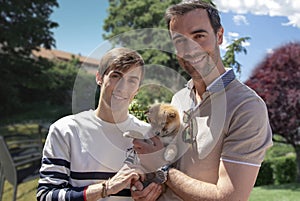 Two young men, gay couple with their puppy, shiba inu dog