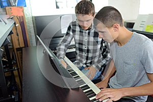 Two young men playing organ