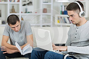 two young men relaxing one in wheelchair
