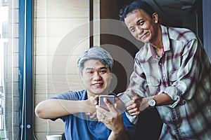 Two young men shake hands to do business