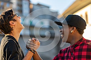 Two young men sharing a good joke laughing together