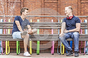 Two young men sitting on a bench