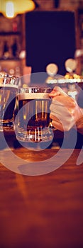 Two young men toasting their beer mugs