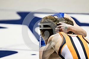 Two young men tying up while wrestling.