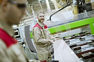 Two young men working in the furniture factory