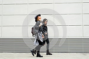 Two young modern women on the street