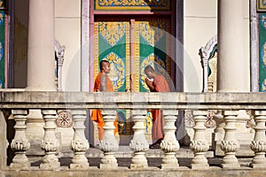 Two young monks meet and salute in buddhist pagoda