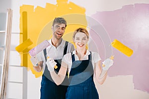 Two young painters smiling at camera