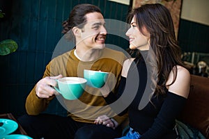 Two young people in cafe enjoying the time spending with each other