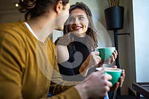 Two young people in cafe enjoying the time spending with each other