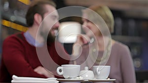 Two young people in cafe enjoying the time spending with each other