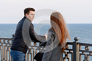 Two young people discuss the situation on the beach