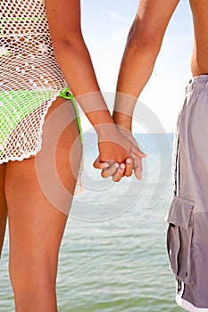 Two Young People Holding Hands by Water