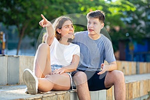 Two young people are sitting in the park