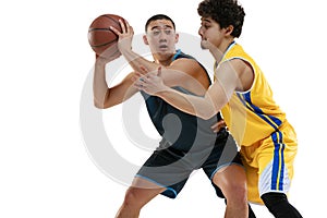 Two young professional basketball players in action, motion  on white studio background. Active lifestyle, sport