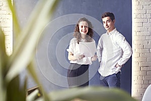 Two young professionals or students woman man happy with business meeting, smiling and talking about project.