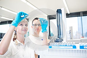 Two young researchers  carrying out scientific research in a lab