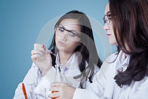 Two young scientists doing chemical research