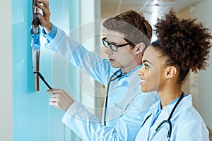 two young smiling doctors examining an