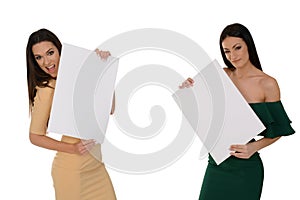 Two young smiling women holding two pieces of blank paper