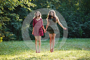 Two young smiling women levitate