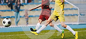 Two Young Soccer Players Kicking Ball on Soccer Field. Soccer Horizontal Background