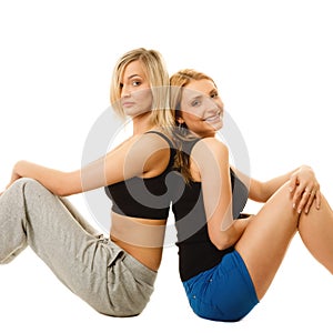 Two young sporty women after intense workout