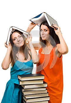 Two young student woman play with books