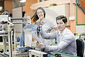 Two young students working on a project together in lab