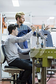 Two young students working on a project together in lab