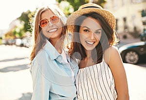 Two young stylish hippie brunette and blond women models