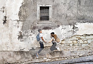 Two young tourists in the old town, having fun.