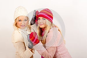 Two young winter girls friends in gloves