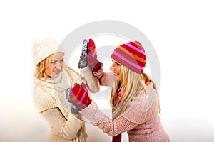 Two young winter woman in gloves and scarfs