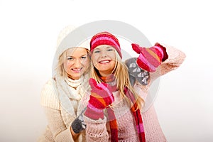 Two young winter woman in gloves and scarfs