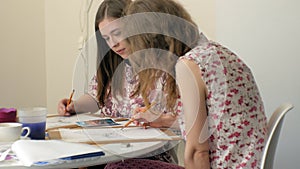 Two young woman artist painting at home studio creative tools