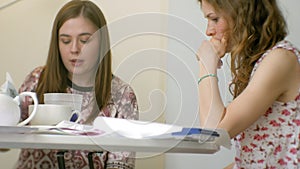 Two young woman artist painting at home studio creative tools