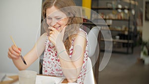 Two Young woman artist painting at home studio creative tools