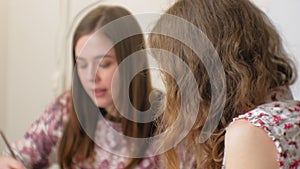 Two Young woman artist painting at home studio creative tools