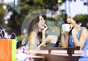 Two young woman chatting in a coffee shop photo