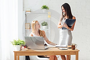 Two young woman colleague at office working