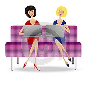 Two young woman with notebook sit on sofa