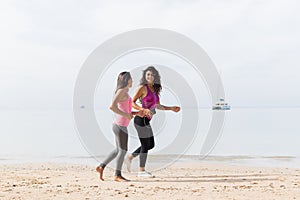 Two Young Woman Running Along Sea Coast Together Slim Girls Jogging On Beach Female Sport Runner Fitness Training
