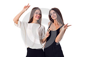 Two young woman showing PEACE