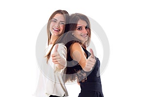 Two young woman showing thumbs up