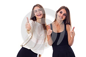 Two young woman showing thumbs up