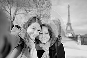 Two young woman taking a selfie near the Eiffel tower