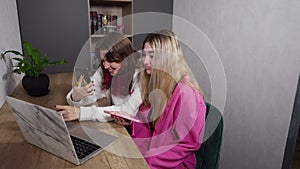 Two young woman watching media together on a laptop computer
