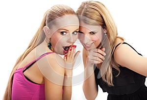 Two young woman wispering secrets photo
