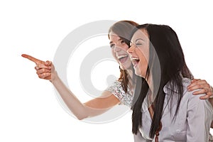Two young women breaking into laughter